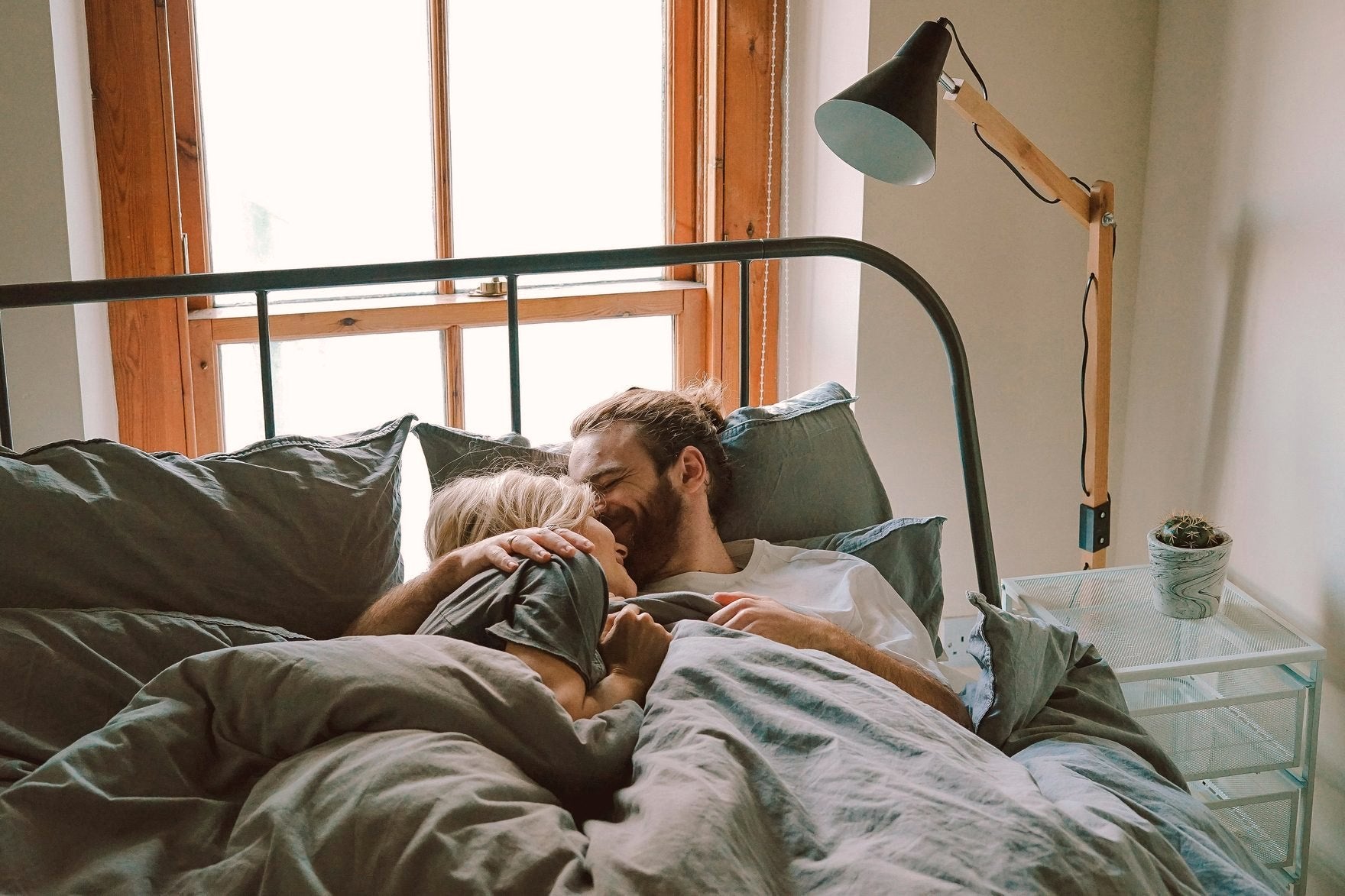 A couple lying close together in bed